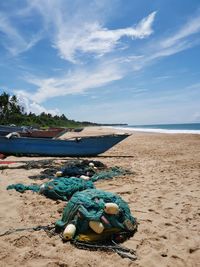 Boats moored on beach against sky