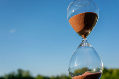 Close-up of hourglass on sunny day