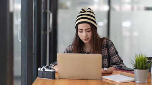 Young woman working on table