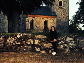 Full length of woman standing against trees