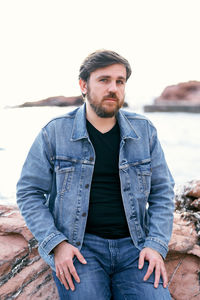 Portrait of young man sitting outdoors