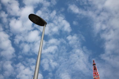 Low angle view of street light against cloudy sky