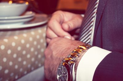 Cropped image of businessman hand wearing wristwatch