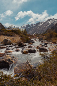 Scenic view of waterfall against sky