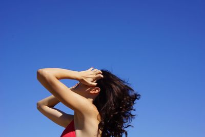 Portrait of woman against blue sky