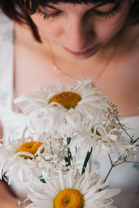 Midsection of woman with flowers