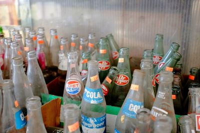 Close-up of wine bottles on glass