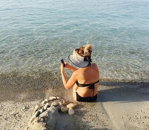 Rear view of woman standing on beach