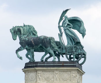 Low angle view of statue against sky