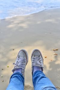 Man's feet on the beach, relaxing on the beach