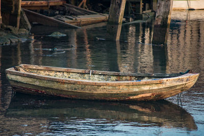 Abandoned boat moored in lake