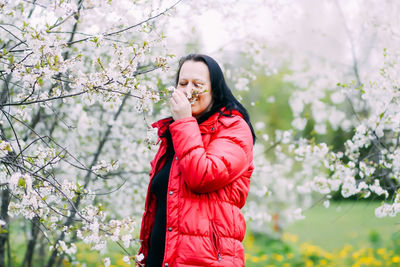 Woman smelling flowers at park