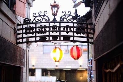 Illuminated lanterns hanging in building