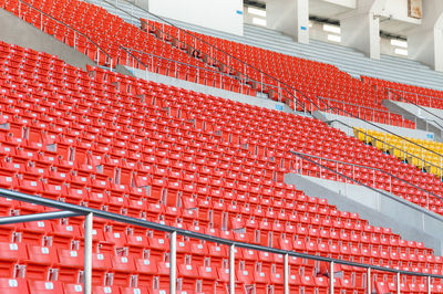 Empty orange seats at stadium,rows walkway of seat on a soccer stadium
