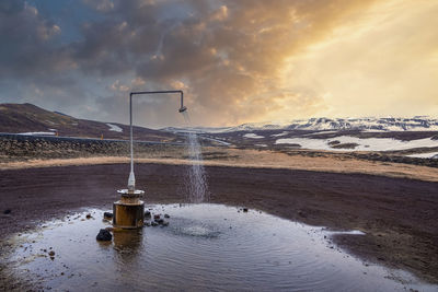 Hot spring shower from geothermal power at krafla against mountain