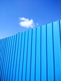 Low angle view of metallic structure against blue sky