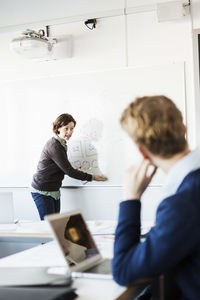 Professor teaching student in classroom