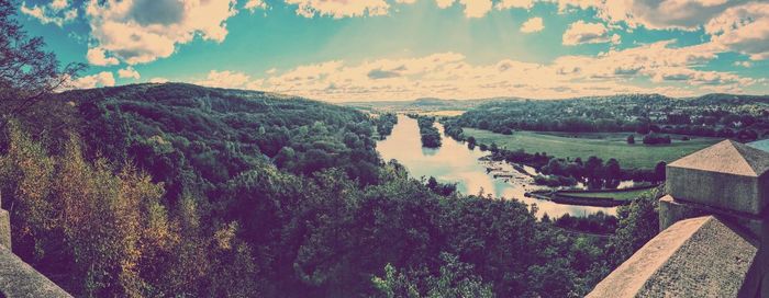 Panoramic view of river and trees against sky