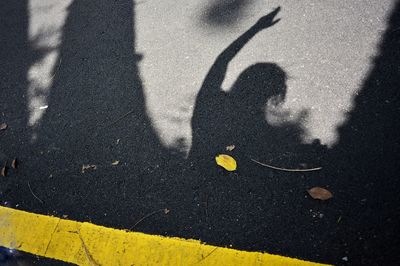 High angle view of people shadow on street