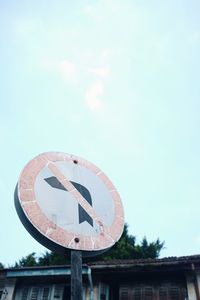 Low angle view of road sign against sky