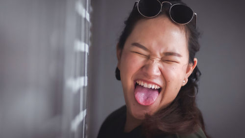 Portrait of smiling young woman with eyes closed