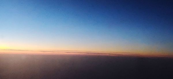Scenic view of landscape against clear sky at sunset