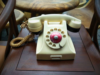 High angle view of old telephone on table