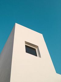 Low angle view of building against clear blue sky