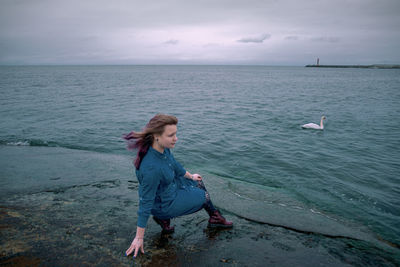 Full length of man in sea against sky