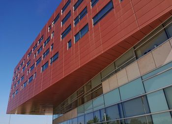 Low angle view of modern building against clear blue sky