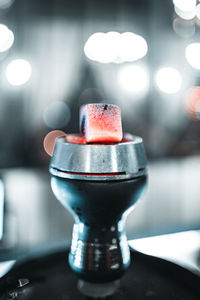 Close-up of illuminated electric lamp on table