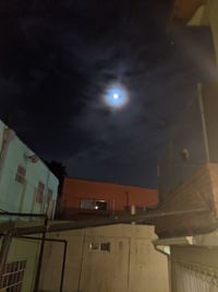 Low angle view of illuminated buildings against sky at night