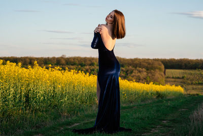 Full length of woman standing on field