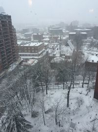 High angle view of snow covered buildings in city