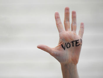 Close-up of human hand against gray background