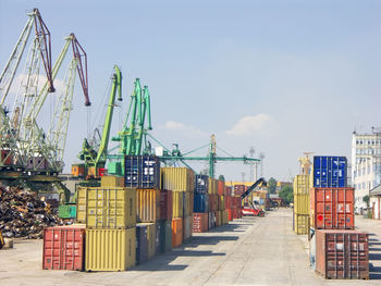 Colorful metal freight containers waiting for loading in port of transshipment