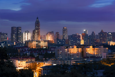 View of skyscrapers lit up at night