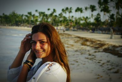 Portrait of smiling young woman at beach