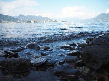 Rocks in sea against sky