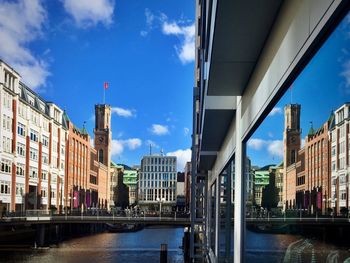 City by river against sky