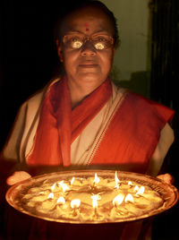 Portrait of man with lit candle