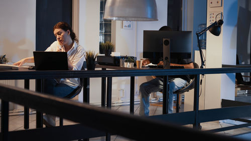 Side view of businessman using laptop at home