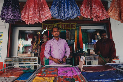 Portrait of a smiling young man standing in market