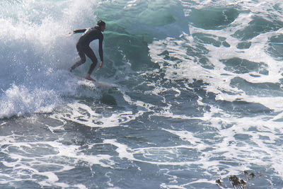 Full length of man surfing in sea