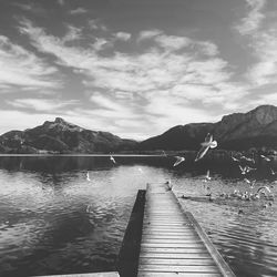 Pier over lake against sky