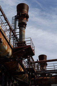 Low angle view of industry against sky