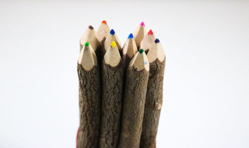 Close-up of colored pencils against white background