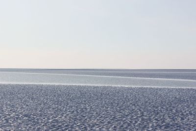 Scenic view of beach against clear sky