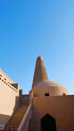 Low angle view of historical building against clear blue sky