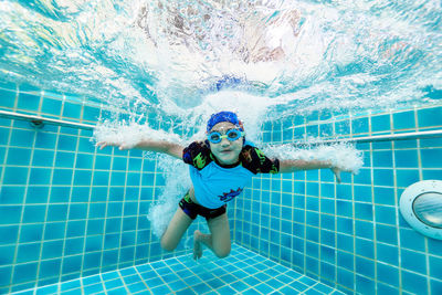 Boy swimming in pool